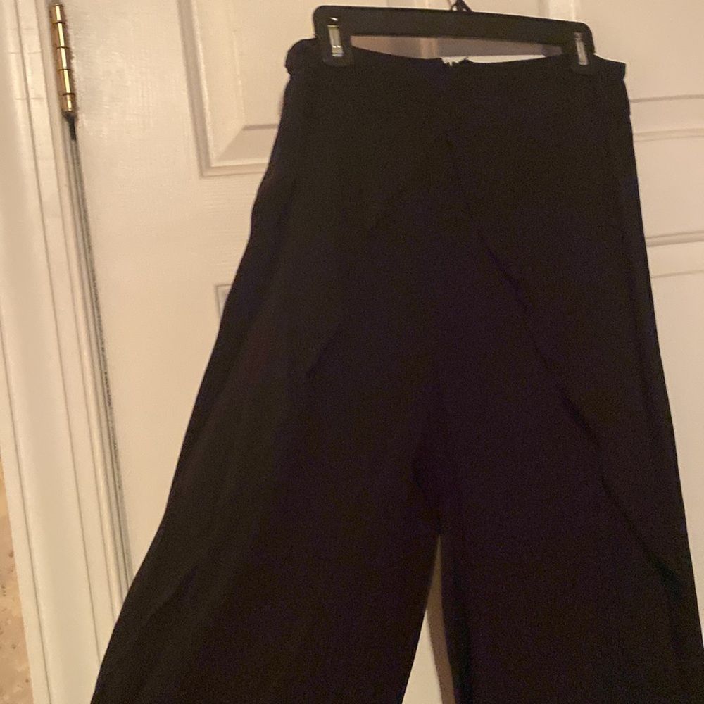 Black palazzo pants that look like a split maxi skirt, side leg has slit.